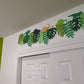 Cappa creations hand made paper banner, handmade designs, Jurassic birthday party theme, dinosaur birthday, tropical dino banner, three-rex birthday celebration, tropical Jurassic banner with monstera and palm leaves, colorful and bold dinosaurs, gold glitter dinos, tyrannosaurs rex, triceratops, long neck, brontosaurus, stegosaurus