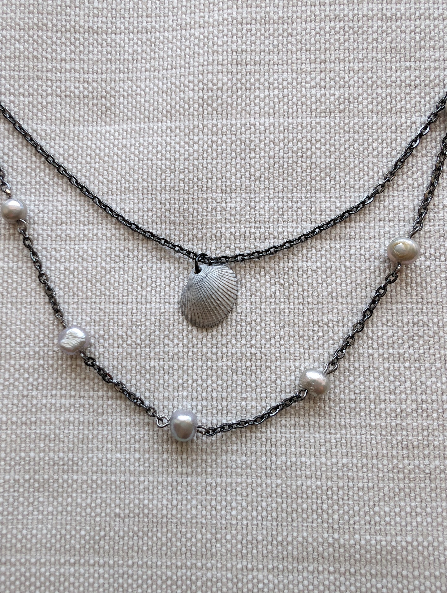 Elevate your style with our Dainty Lavender Pearl Necklace! This elegant piece features delicate lavender grey pearls on a sleek gunmetal chain. Perfect for any occasion, this necklace adds a touch of sophistication to any outfit. Upgrade your jewelry collection today! layered bohemian necklaces by cappa creations, tropical beachy jewelry, freshwater pearls, layered necklaces