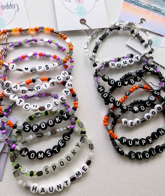 Customizable Spooky Vibes bracelet made of seed beads and hematite with personalized colors, letters, and wording by Cappa Creations.