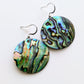 Close-up of 18k gold plated abalone shell earrings with white gold hooks, showcasing their iridescent 30 mm shells.